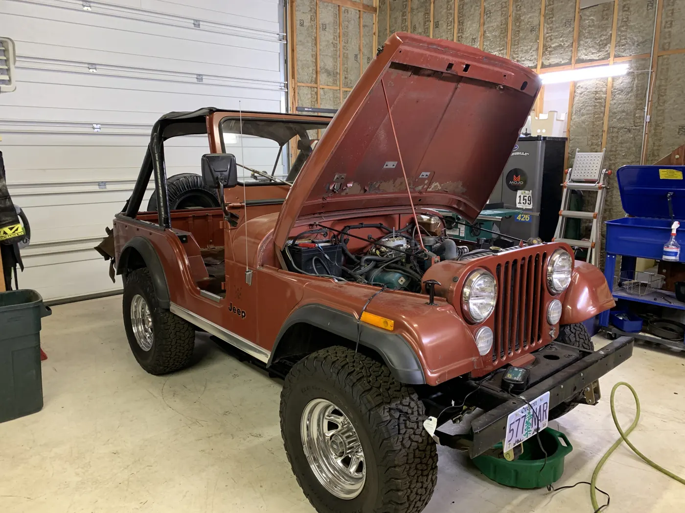 CJ5 in the garage with the hood up during reassembly